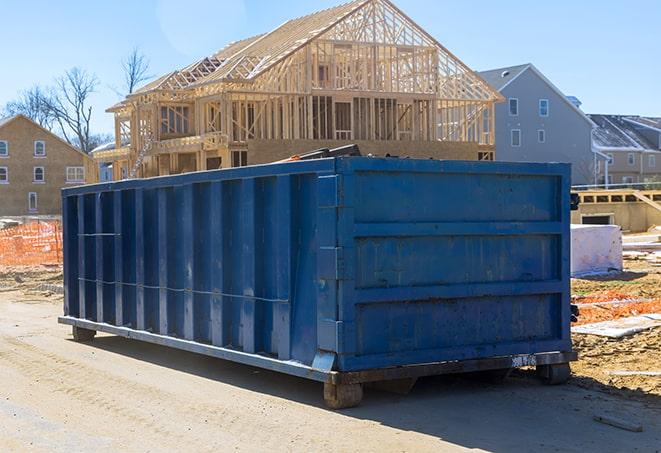 a lineup of residential dumpsters for community recycling programs